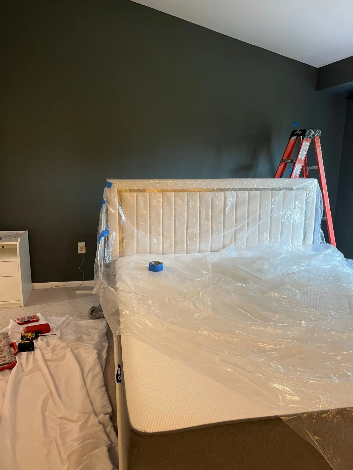 Plain charcoal bedroom wall before the slat wall
