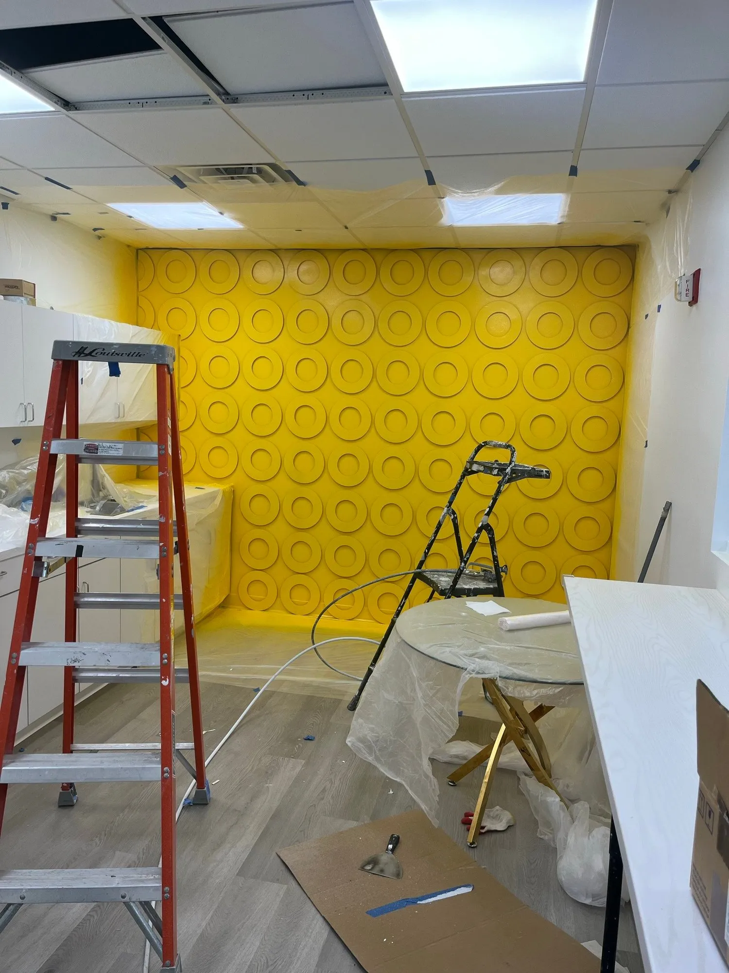 Yellow 3D circle wall panels going up as a break room feature wall