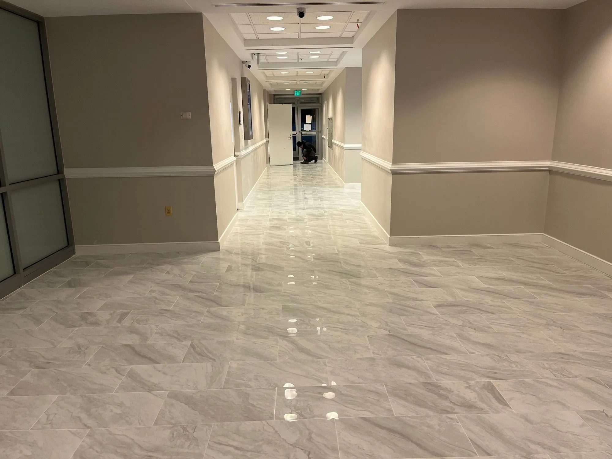 Office corridor with new large-format porcelain tile down the whole hallway