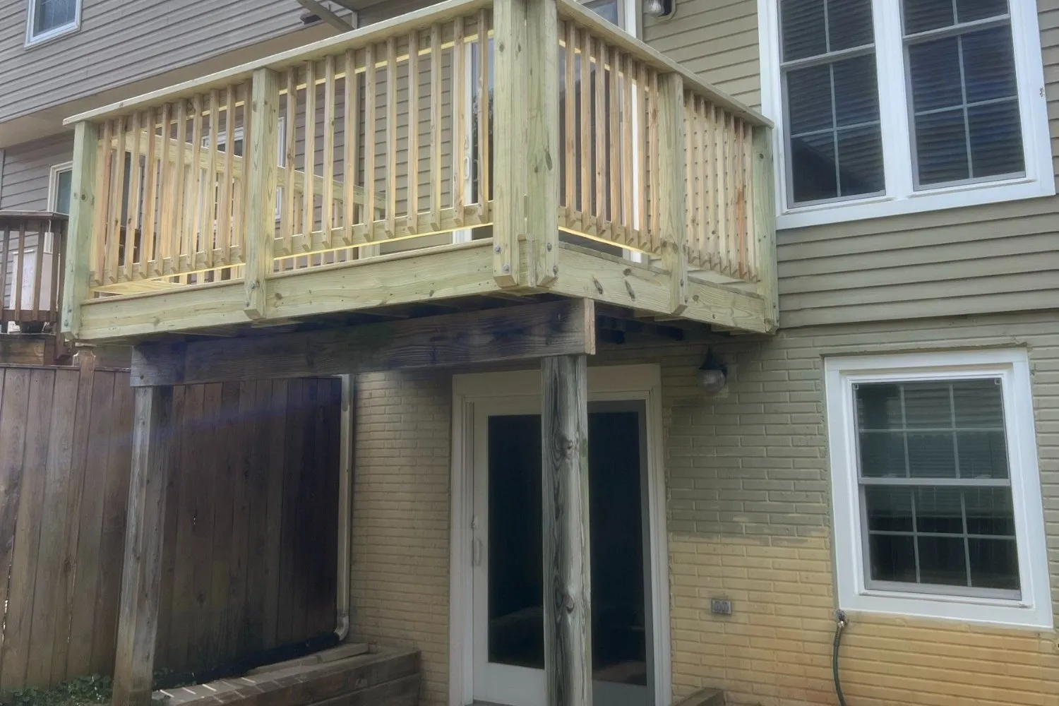 Finished pressure-treated deck with new railings