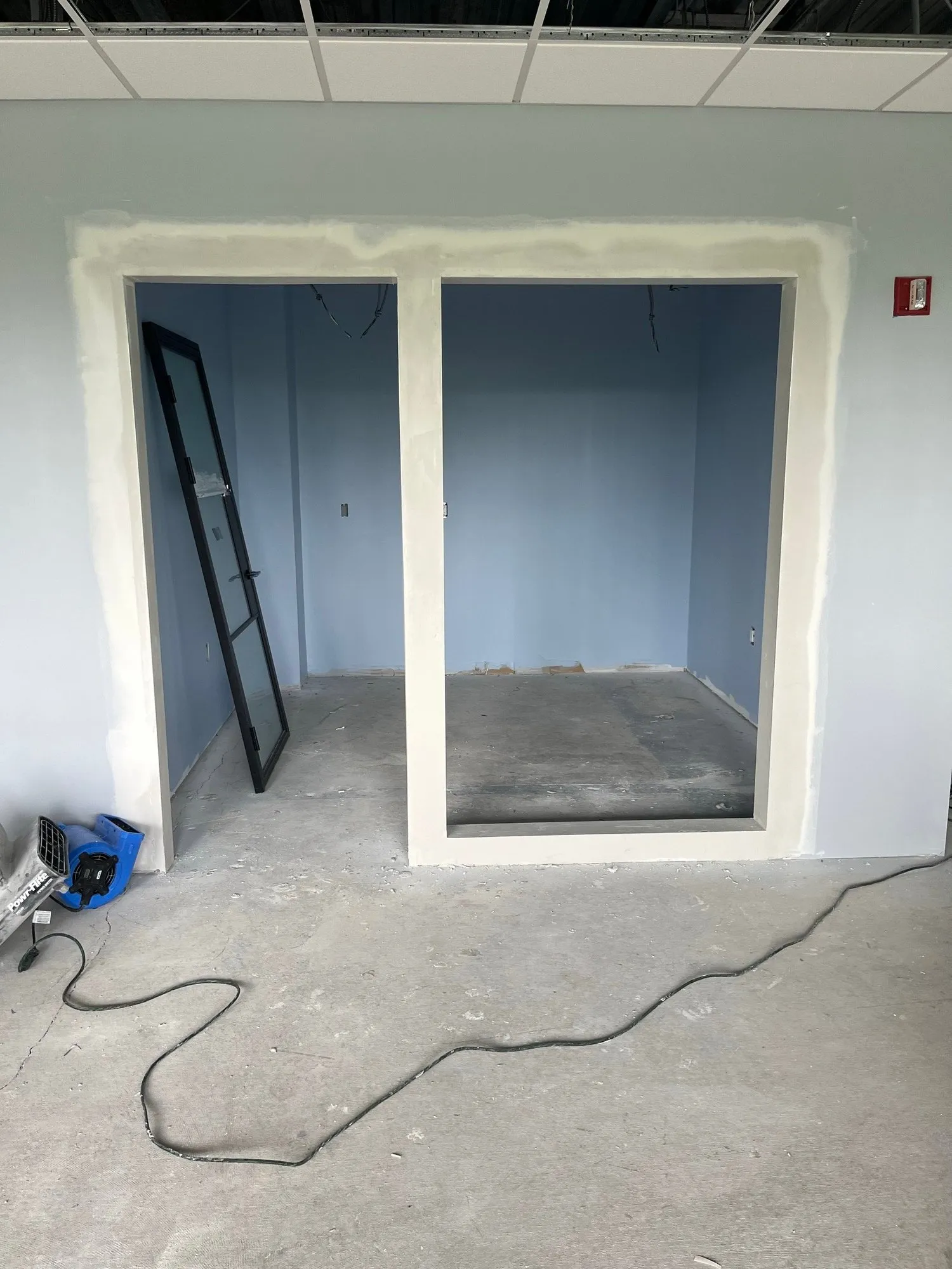 Wrapped door and window openings in a new office wall
