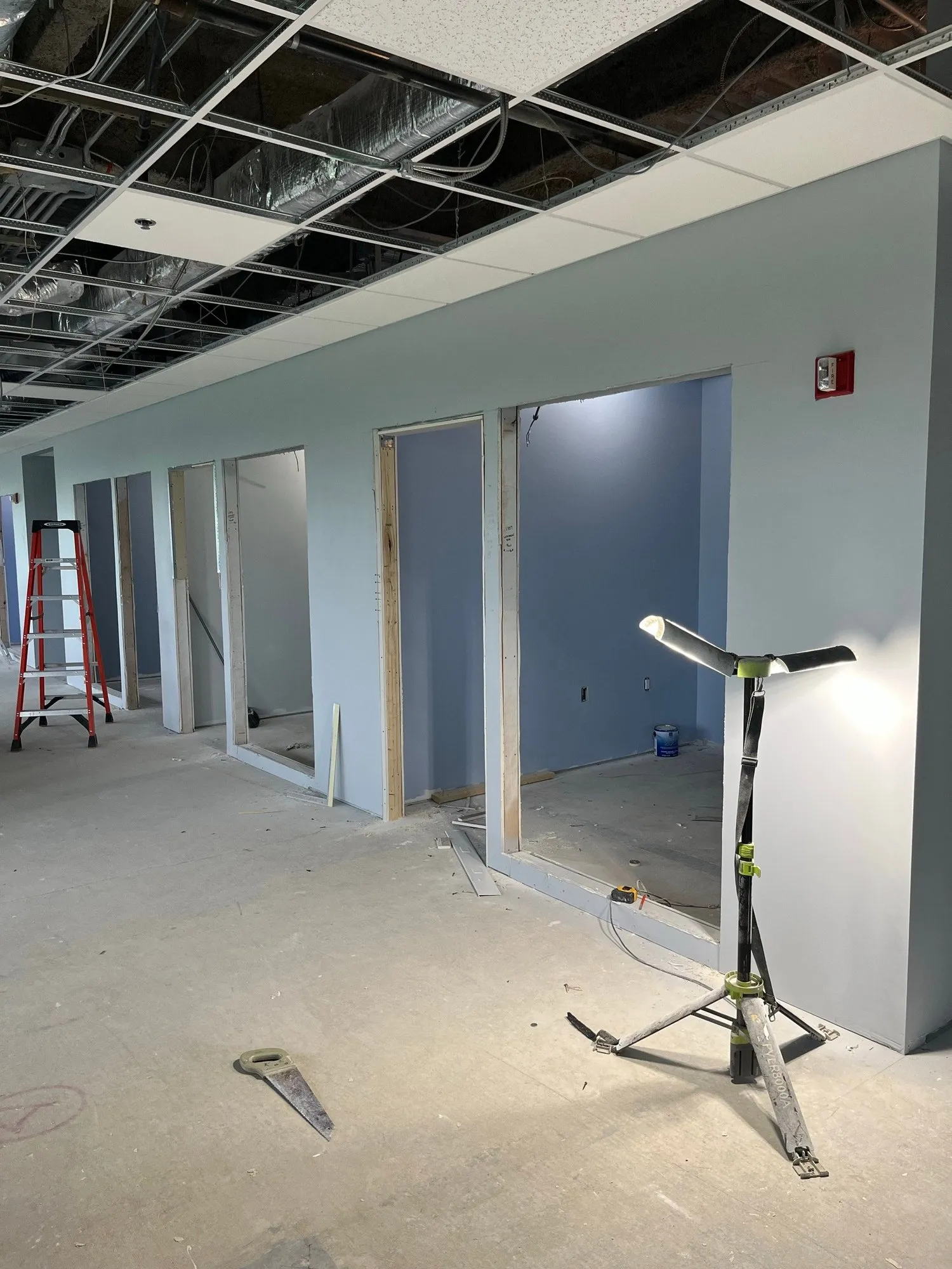 Row of new offices drywalled and painted, door frames in