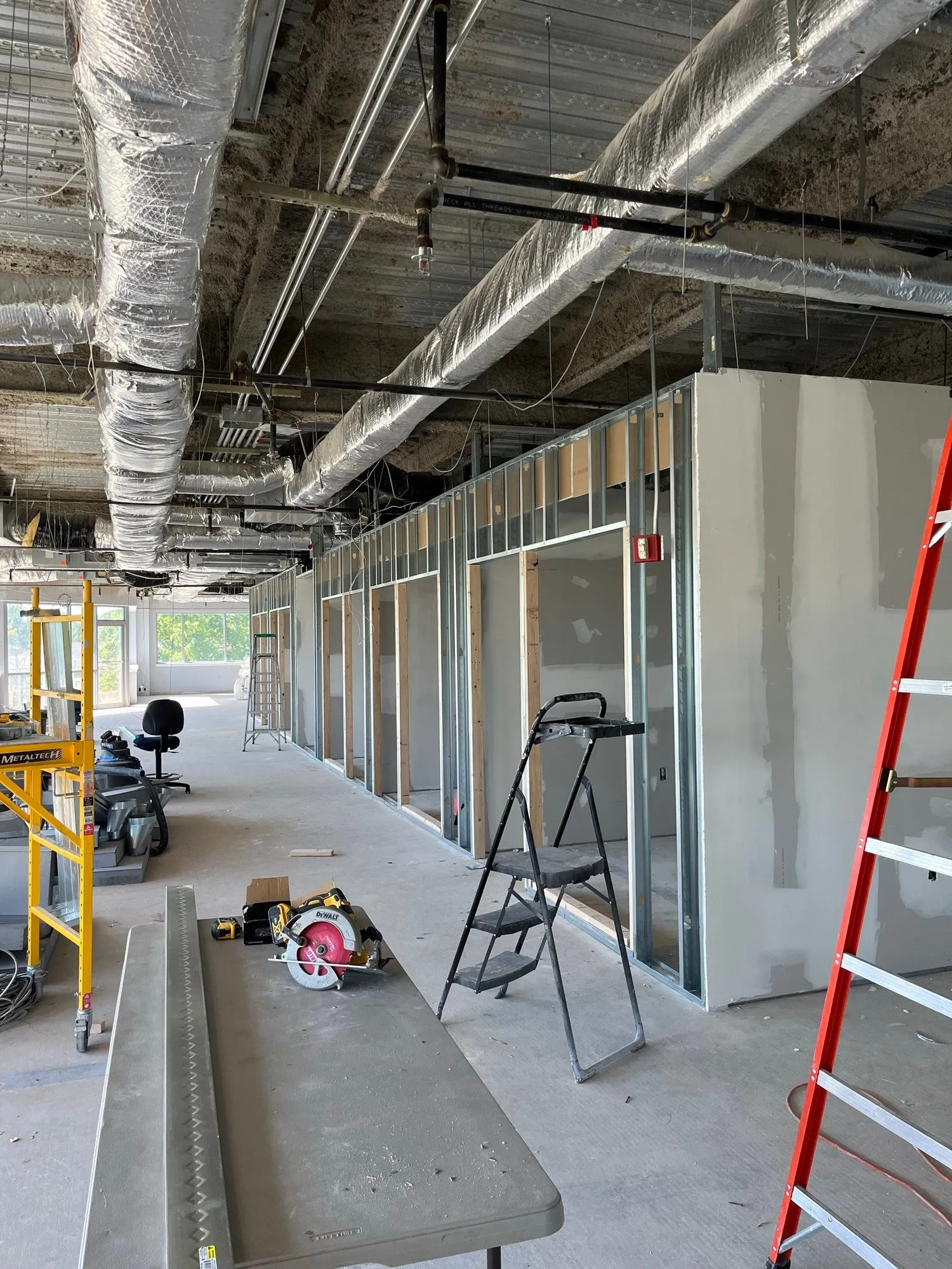 Metal-stud office walls framed and partly drywalled