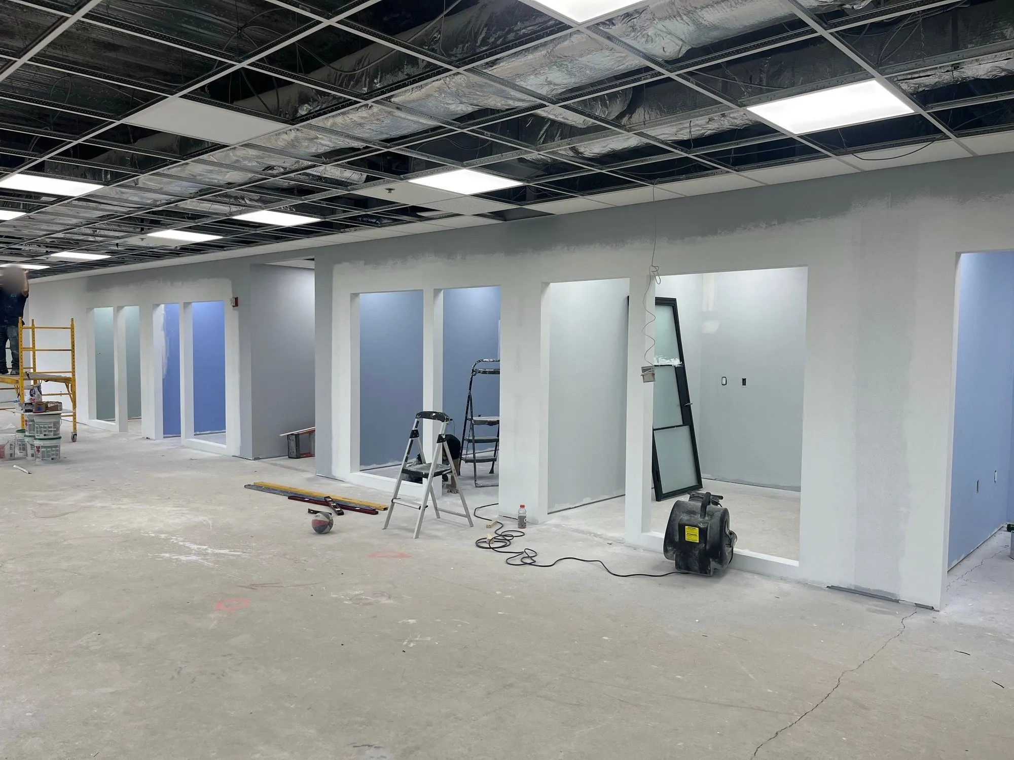 Painted office suite with a row of new door openings