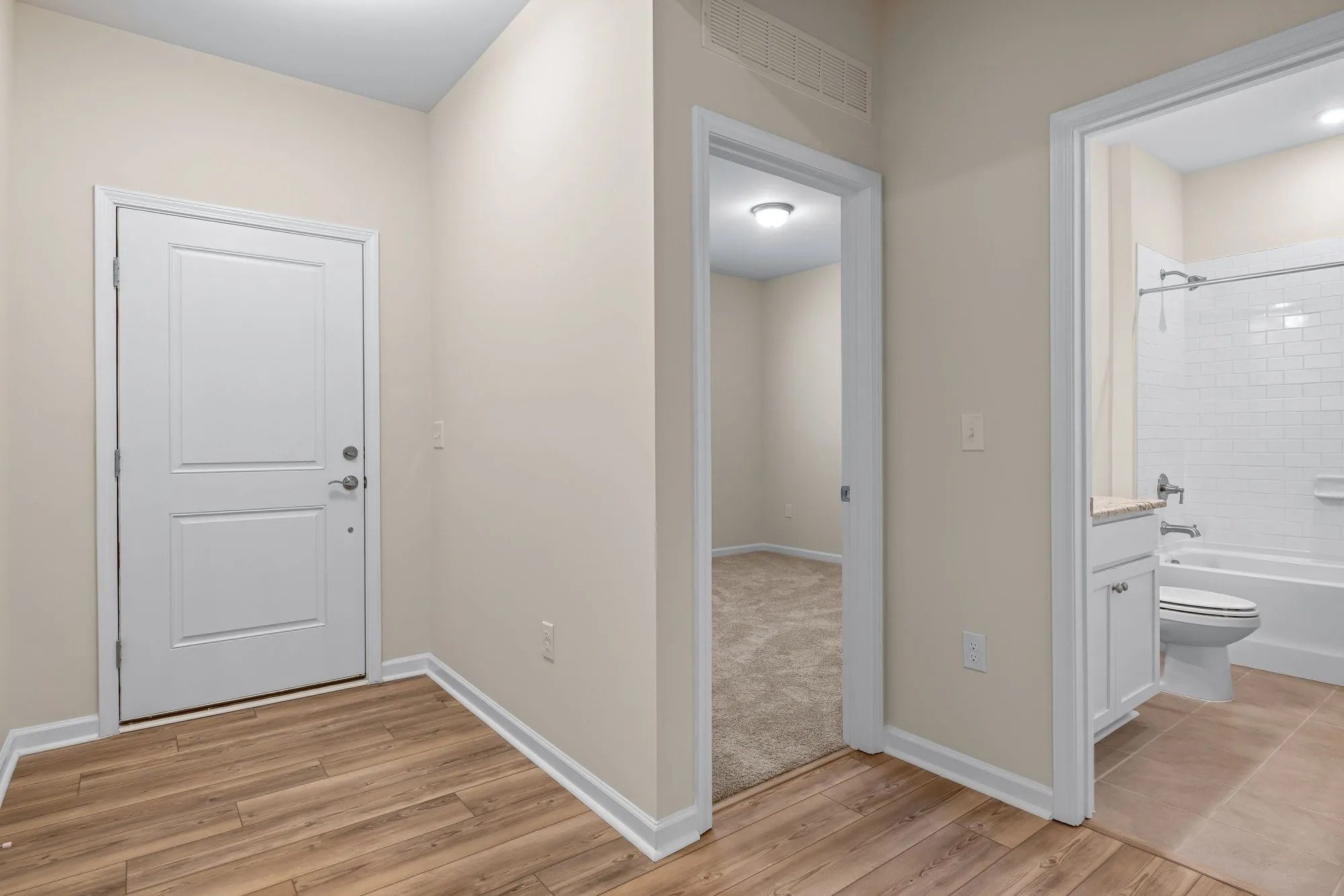 White interior door and trim in a bright hallway