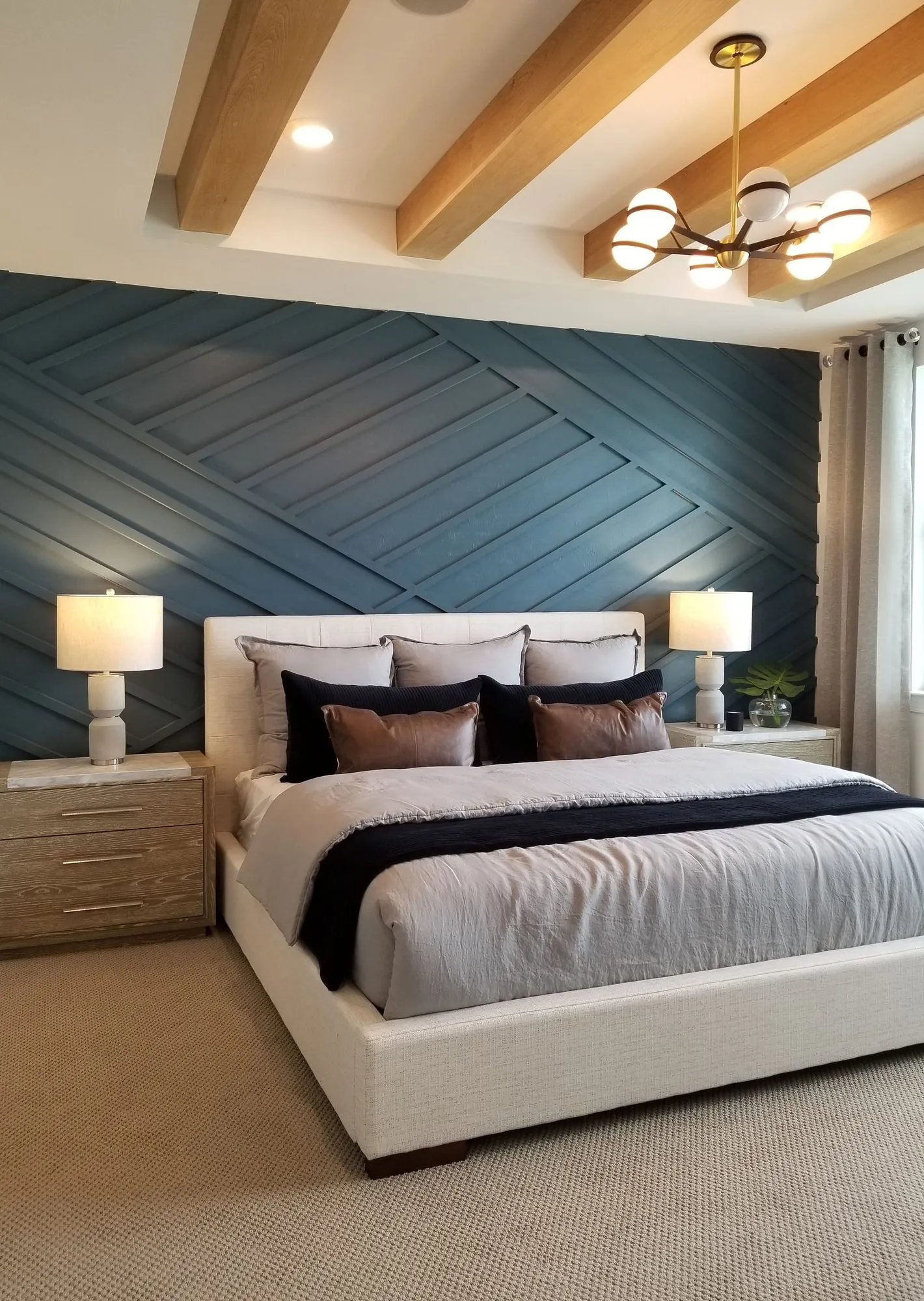 A navy wood-trim accent wall behind a bed