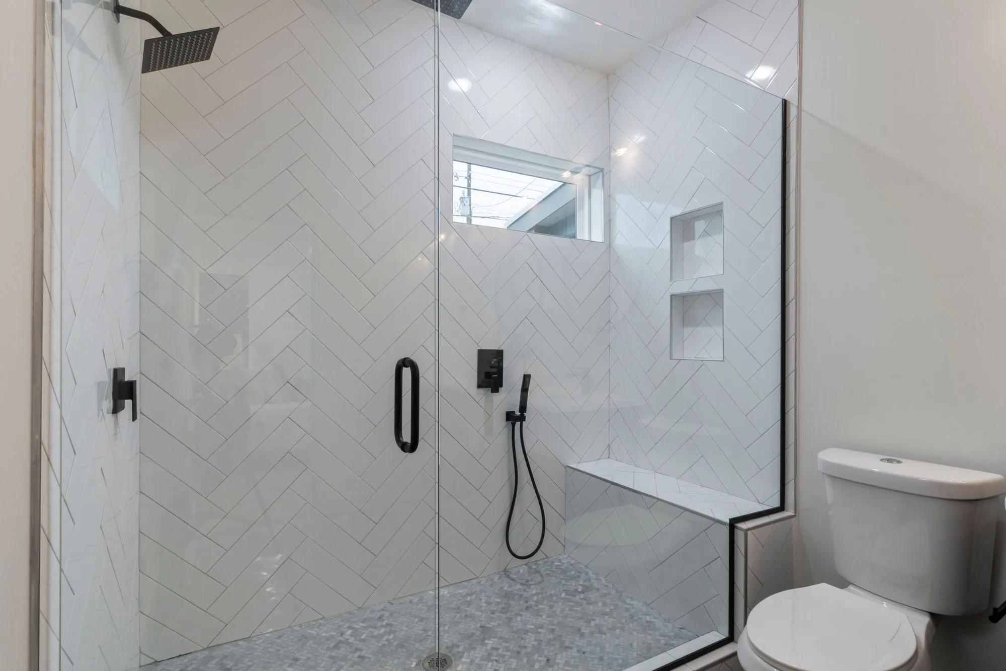A remodeled bathroom with a walk-in shower